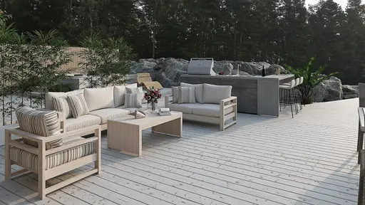 Exteriör terrass med lounge, utekök/grill och omgivande klippor och grönska.